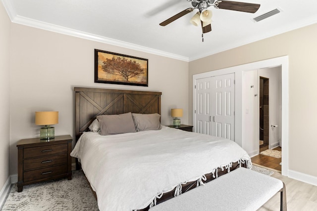 3695 Scenic Highway 98 Unit 1002, Destin, FL 32541 - bedroom with ornamental molding, light wood finished floors, baseboards, a closet, and a ceiling fan