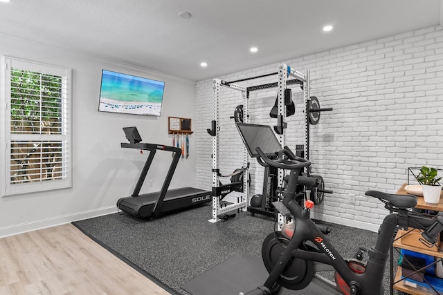3695 Scenic Highway 98 Unit 1002, Destin, FL 32541 - exercise area featuring brick wall, wood finished floors, baseboards, and recessed lighting