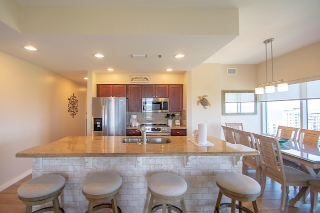5000 S Sandestin Blvd Unit 7906, Miramar Beach, FL 32550 - kitchen featuring appliances with stainless steel finishes, a sink, a breakfast bar area, recessed lighting, and hanging light fixtures