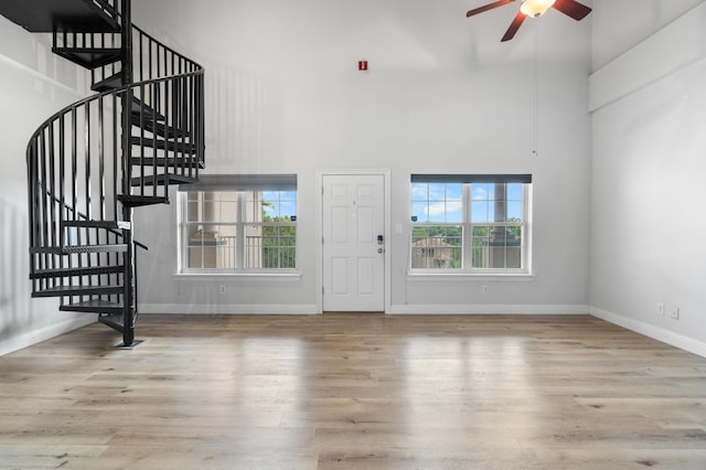 4507 Furling Ln Unit 302, Destin, FL 32541 - entryway with a ceiling fan, plenty of natural light, stairs, wood finished floors, and a towering ceiling