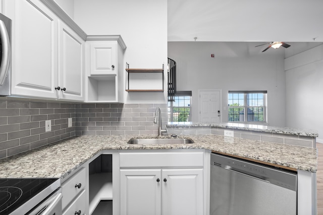 4507 Furling Ln Unit 302, Destin, FL 32541 - kitchen featuring a sink, dishwasher, a ceiling fan, a peninsula, and open shelves