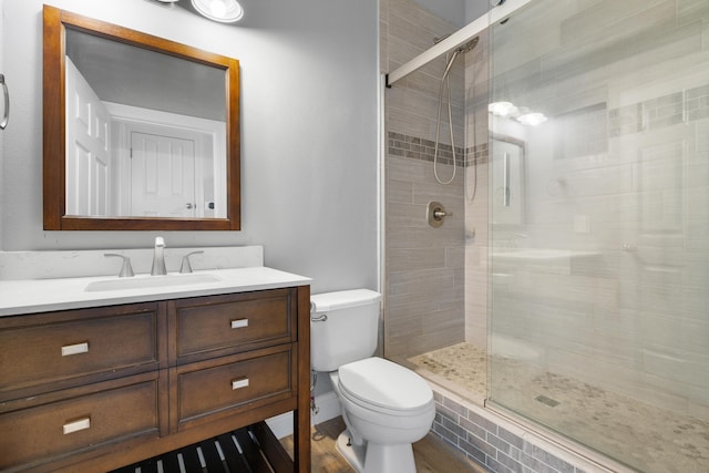 4507 Furling Ln Unit 302, Destin, FL 32541 - full bathroom with toilet, vanity, a stall shower, and wood finished floors