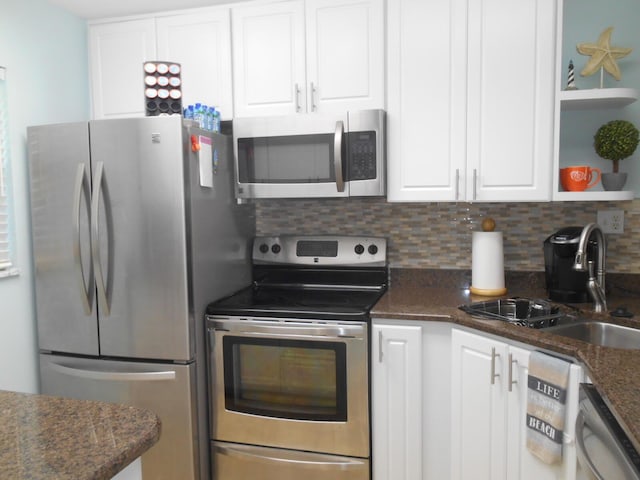 3857 Indian Trl Unit 203, Destin, FL 32541 - kitchen featuring stainless steel appliances, a sink, white cabinets, and tasteful backsplash