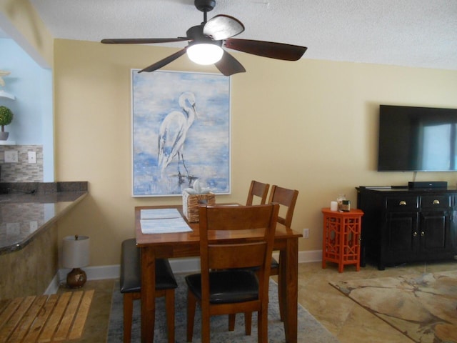 3857 Indian Trl Unit 203, Destin, FL 32541 - dining area featuring ceiling fan, baseboards, and a textured ceiling