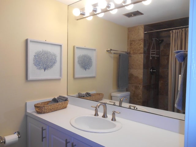 3857 Indian Trl Unit 203, Destin, FL 32541 - bathroom with vanity, toilet, and tiled shower