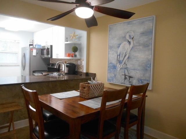3857 Indian Trl Unit 203, Destin, FL 32541 - dining space with a ceiling fan and baseboards
