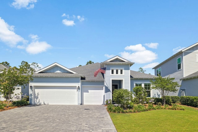 282 W Lafayette Rd, Inlet Beach, FL 32461 - view of front of house with a garage, decorative driveway, a front yard, and roof with shingles