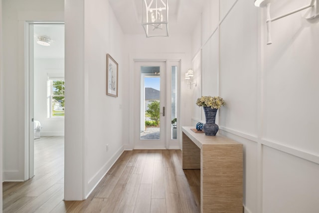 282 W Lafayette Rd, Inlet Beach, FL 32461 - doorway featuring light wood-style floors and a chandelier