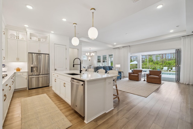 282 W Lafayette Rd, Inlet Beach, FL 32461 - kitchen featuring stainless steel appliances, open floor plan, a chandelier, light countertops, and glass insert cabinets