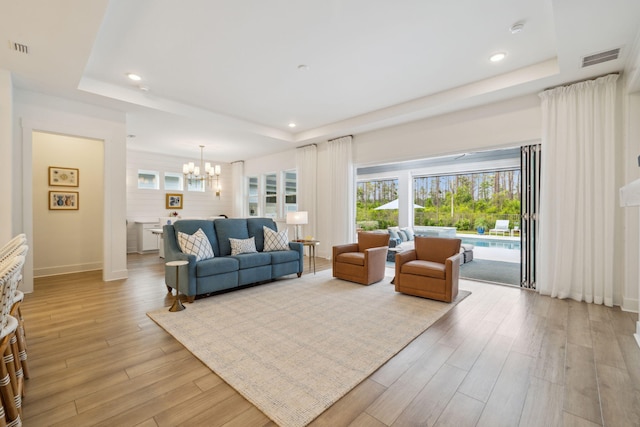 282 W Lafayette Rd, Inlet Beach, FL 32461 - living area featuring a tray ceiling, a chandelier, recessed lighting, and light wood-style floors