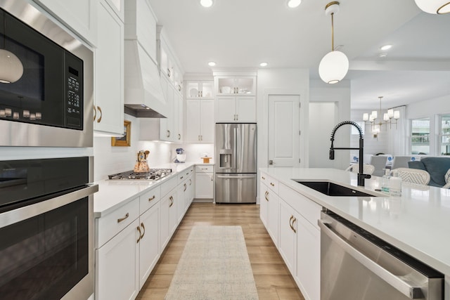 282 W Lafayette Rd, Inlet Beach, FL 32461 - kitchen featuring stainless steel appliances, light countertops, decorative light fixtures, glass insert cabinets, and backsplash