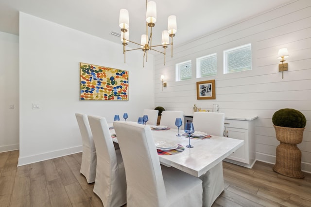 282 W Lafayette Rd, Inlet Beach, FL 32461 - dining room featuring a chandelier, wood finished floors, and wood walls