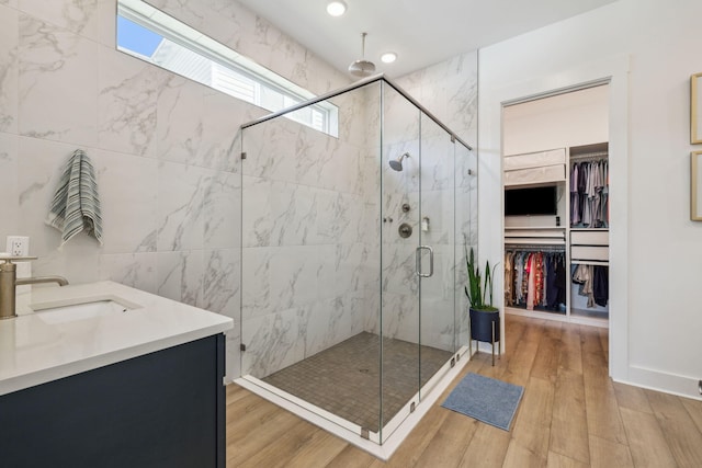 282 W Lafayette Rd, Inlet Beach, FL 32461 - full bathroom featuring a marble finish shower, wood finished floors, a walk in closet, vanity, and recessed lighting
