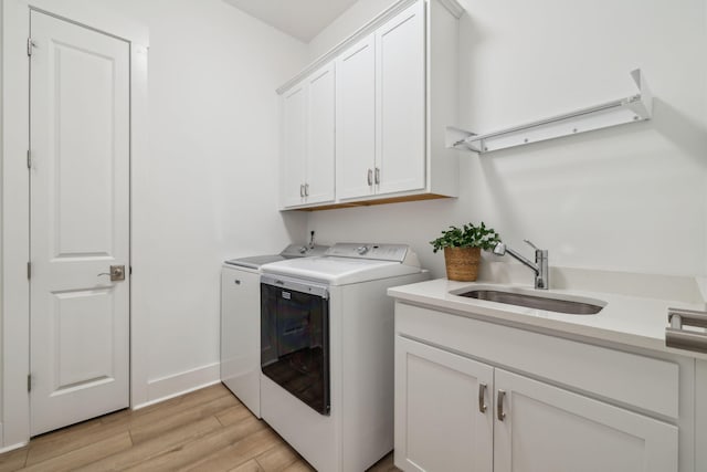 282 W Lafayette Rd, Inlet Beach, FL 32461 - washroom with washer and clothes dryer, cabinet space, and light wood-style flooring