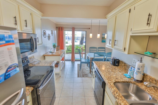196 N Driftwood Bay Unit 38A, Miramar Beach, FL 32550 - kitchen featuring stainless steel appliances, a sink, crown molding, cream cabinets, and light stone counters