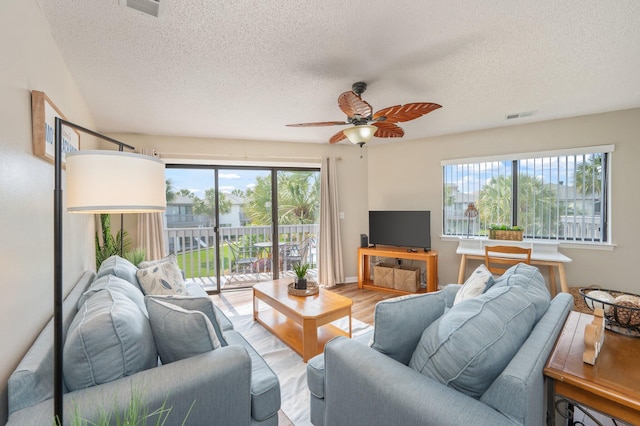 285 Payne St Unit 23B, Miramar Beach, FL 32550 - living area with a textured ceiling, a ceiling fan, and wood finished floors