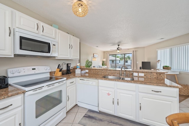 285 Payne St Unit 23B, Miramar Beach, FL 32550 - kitchen featuring white appliances, light tile patterned flooring, a sink, a peninsula, and ceiling fan