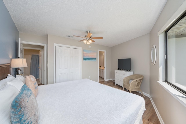 285 Payne St Unit 23B, Miramar Beach, FL 32550 - bedroom featuring wood finished floors, baseboards, a ceiling fan, a closet, and ensuite bathroom