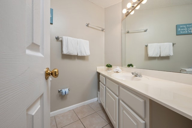 285 Payne St Unit 23B, Miramar Beach, FL 32550 - bathroom featuring vanity, tile patterned flooring, baseboards, and a textured ceiling
