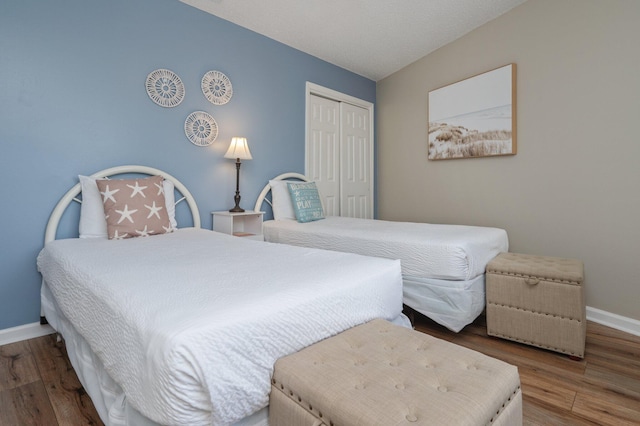 285 Payne St Unit 23B, Miramar Beach, FL 32550 - bedroom featuring a closet, baseboards, and wood finished floors