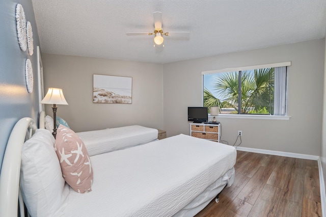 285 Payne St Unit 23B, Miramar Beach, FL 32550 - bedroom with wood finished floors, baseboards, and a ceiling fan