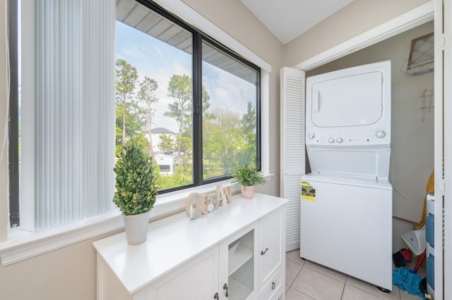 285 Payne St Unit 23B, Miramar Beach, FL 32550 - laundry area with stacked washer / dryer and light tile patterned floors
