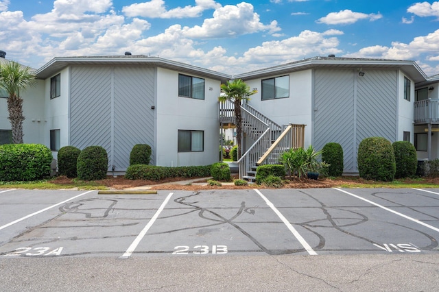 285 Payne St Unit 23B, Miramar Beach, FL 32550 - view of building exterior featuring uncovered parking and stairs