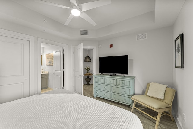15928 Front Beach Rd # 32003, Panama City Beach, FL 32413 - bedroom featuring wood finished floors, baseboards, connected bathroom, and a ceiling fan