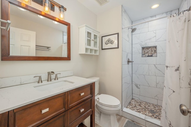 4467 Turnberry Pl, Niceville, FL 32578 - full bathroom with vanity, toilet, a tile shower, recessed lighting, and wood finished floors