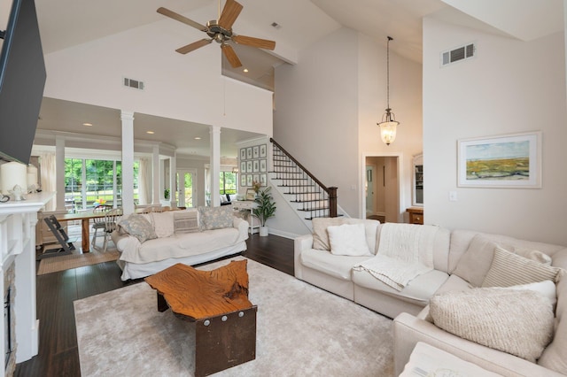 4467 Turnberry Pl, Niceville, FL 32578 - living room with high vaulted ceiling, ornate columns, a ceiling fan, dark wood-style flooring, and stairs
