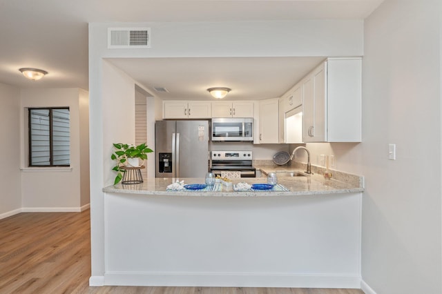 308 Miracle Strip Pkwy Unit 16B, Fort Walton Beach, FL 32548 - kitchen with appliances with stainless steel finishes, a sink, light stone countertops, and baseboards