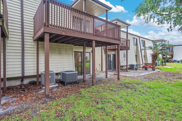 308 Miracle Strip Pkwy Unit 16B, Fort Walton Beach, FL 32548 - rear view of property with cooling unit, a patio area, and a wooden deck