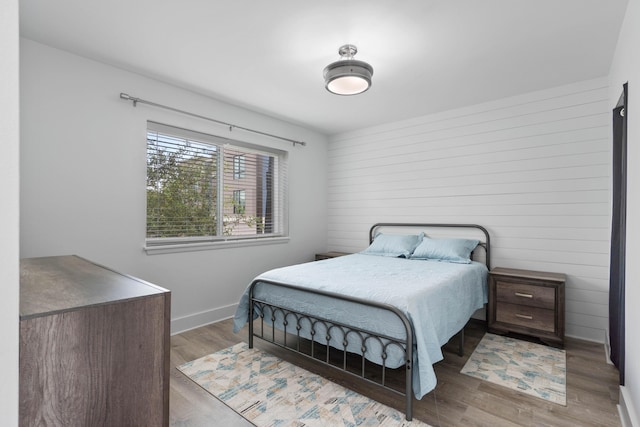 4 SW Miracle Strip Pkwy Unit 23, Fort Walton Beach, FL 32548 - bedroom with wood finished floors, baseboards, and wood walls