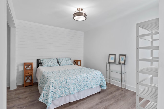 4 SW Miracle Strip Pkwy Unit 23, Fort Walton Beach, FL 32548 - bedroom with wood finished floors and wooden walls