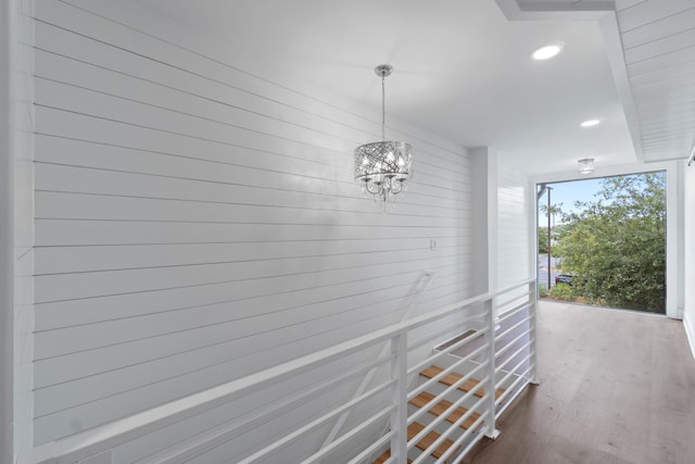 4 SW Miracle Strip Pkwy Unit 23, Fort Walton Beach, FL 32548 - hallway with recessed lighting, dark wood-style flooring, an upstairs landing, a chandelier, and expansive windows