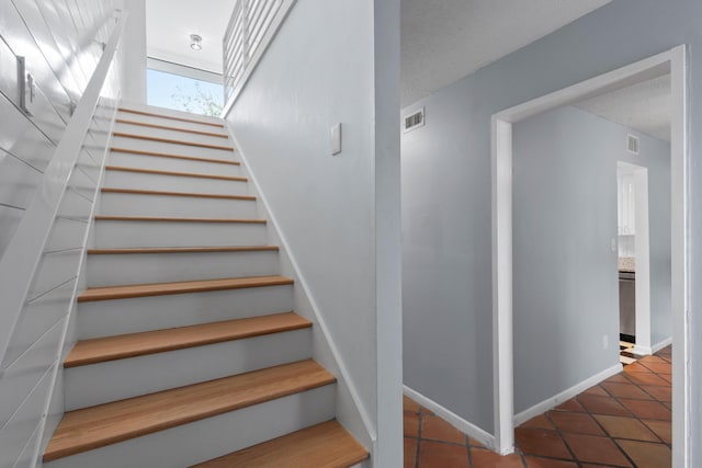 4 SW Miracle Strip Pkwy Unit 23, Fort Walton Beach, FL 32548 - stairway with tile patterned flooring and baseboards