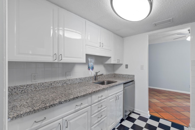 4 SW Miracle Strip Pkwy Unit 23, Fort Walton Beach, FL 32548 - kitchen featuring a sink, stainless steel dishwasher, white cabinets, a textured ceiling, and tasteful backsplash