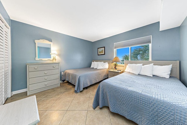 667 Nautilus Ct Unit 302, Fort Walton Beach, FL 32548 - bedroom with tile patterned floors, a closet, and baseboards