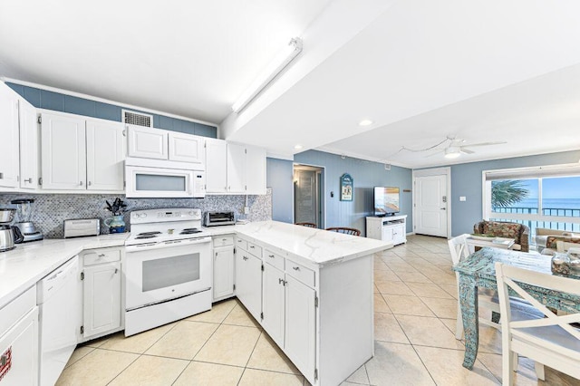 667 Nautilus Ct Unit 302, Fort Walton Beach, FL 32548 - kitchen with white appliances, tasteful backsplash, a peninsula, white cabinetry, and recessed lighting