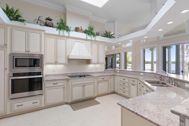 23 Paradise Point Rd, Shalimar, FL 32579 - kitchen with stainless steel appliances, custom exhaust hood, a sink, cream cabinets, and light stone counters