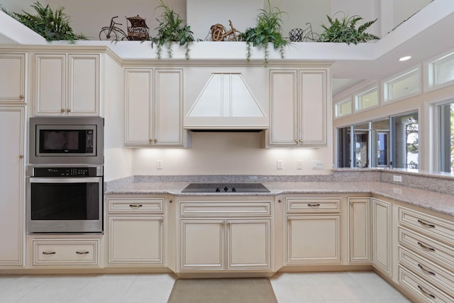 23 Paradise Point Rd, Shalimar, FL 32579 - kitchen featuring stainless steel appliances, cream cabinets, custom exhaust hood, and light tile patterned floors