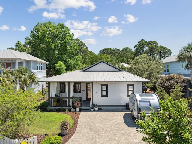 300 Cassine Garden Cir, Santa Rosa Beach, FL 32459 - view of front of home with a porch, a metal roof, and a front lawn