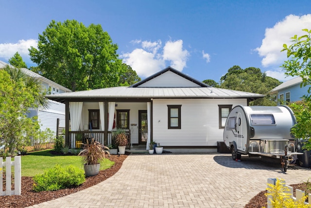 300 Cassine Garden Cir, Santa Rosa Beach, FL 32459 - view of front of property featuring covered porch, a metal roof, and a front yard