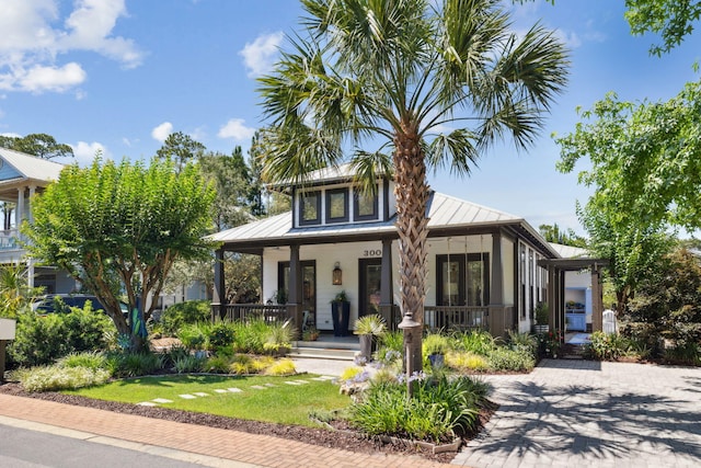 300 Cassine Garden Cir, Santa Rosa Beach, FL 32459 - view of front of property featuring a standing seam roof, a porch, a metal roof, and a front lawn