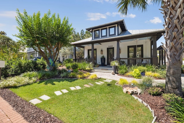 300 Cassine Garden Cir, Santa Rosa Beach, FL 32459 - view of front of house with a front lawn, a metal roof, and covered porch