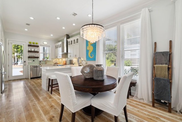 300 Cassine Garden Cir, Santa Rosa Beach, FL 32459 - dining room featuring ornamental molding, a chandelier, recessed lighting, and light wood finished floors