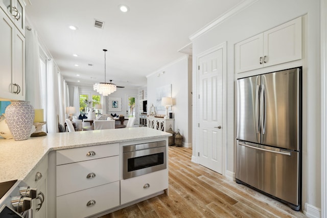 300 Cassine Garden Cir, Santa Rosa Beach, FL 32459 - kitchen featuring freestanding refrigerator, a peninsula, white cabinets, light stone counters, and light wood-style floors