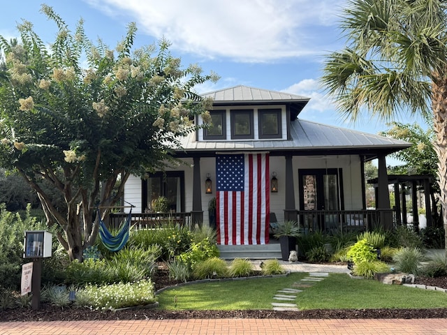 300 Cassine Garden Cir, Santa Rosa Beach, FL 32459 - view of front of house featuring a porch, a metal roof, and a standing seam roof
