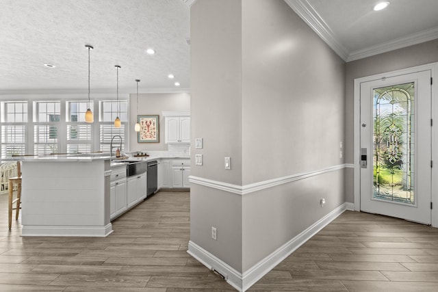 72 Tranquility Ln, Destin, FL 32541 - foyer with light wood finished floors, crown molding, recessed lighting, and baseboards