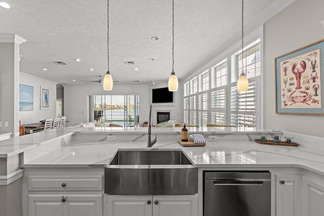 72 Tranquility Ln, Destin, FL 32541 - kitchen featuring stainless steel dishwasher, a glass covered fireplace, open floor plan, ornamental molding, and a sink